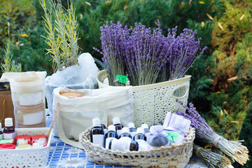  Fresh purple lavender with flacons of essential oil for aromatherapy, alternate medicine and perfumery at market stall.