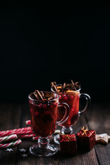 Christmas holidays atmosphere, cold winter day. Warming mood. Mulled wine with cranberry, cinnamon, orange and anise.