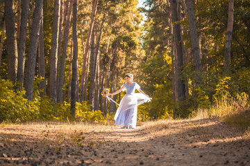 Fototapeta na wymiar happy bride with a bouquet is walking the green park