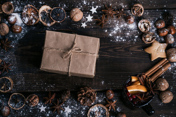 Christmas and New Year holidays preparations. Decorating presents, DIY, celebration concept. Christmas background with homemade gingerbread cookies, mulled wine and gift box