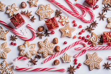 Christmas composition, New Year greeting card. Mockup with festive food decorations and gingerbread cookies on white background, creative texture