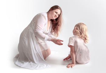 Young overweight mother holds out her little daughter's arms. Parent Confidence and Parental Assistance Concept.