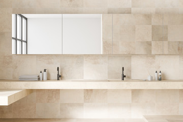 Beige tile bathroom interior with double sink