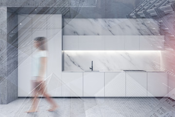 Woman walking in marble and concrete kitchen