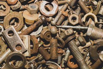 Pile of fasteners and screws close up. scrap metal. different metal parts