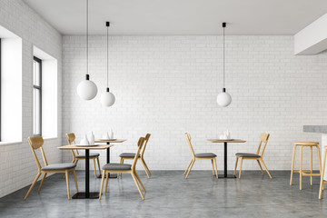 White brick loft cafe interior with tables