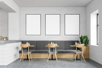 White brick loft restaurant with sofa and posters