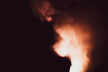Colored smoke on black backdrop. abstract background with brown fog