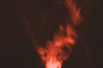 Colored smoke on black backdrop. abstract background with brown fog