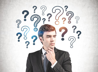 Thoughtful businessman with many questions
