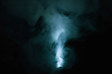 Turquoise smoke on black backdrop. abstract background with color fog