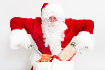 Amazed Santa riding a bike with Christmas presents