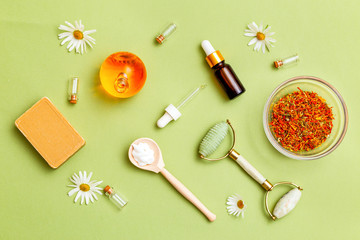 Herbal medicine and  natural skin care products on green background. Modern apothecary