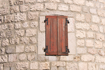 Old closed wooden window. Window in the old fortress.