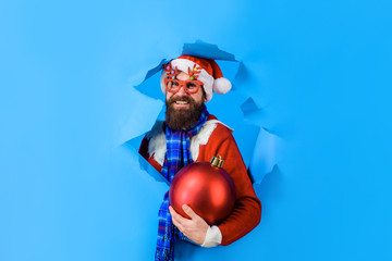 Santa Claus man holds big christmas ball. Winter holidays. New year. Discount. Sale. Christmas...