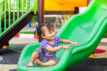 Fototapeta na wymiar Portrait image of 1-2 yeas old baby. Happy Asian child girl smiling and laughing. She playing with slider bar toy at the playground. Learning and active of kids concept. 