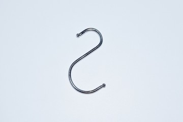 s shaped stainless steel hook on a white background