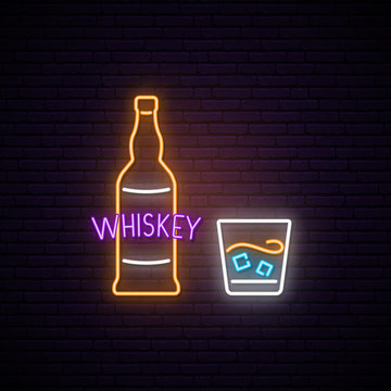 Neon Whiskey sign. Bright light signboard with bottle and glass of whiskey.