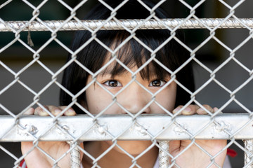 little girl hold cage with eye sad and hopeless, Human trafficking concept, human rights...