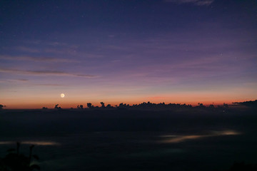 morning sunrise covered with fog and sky background with stars