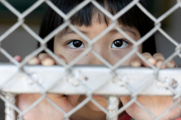 little girl hold cage with eye sad and hopeless, Human trafficking concept, human rights...