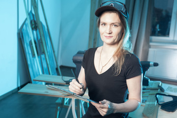 A girl in a black t-shirt looks at the camera. Woman in the Studio. The girl comes up with a new...