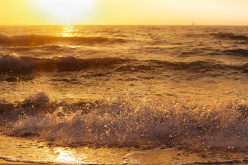 Obraz premium Sunset over the sea. Reflection of sunlight in the sea waves. The sky in the sunset rays.