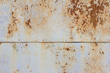 Light blue corroded metal background. Rusty and scratched painted metal wall. Rusty metal background with streaks of rust .
