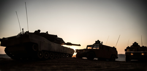 Military patrol car on sunset background. Army war concept. Silhouette of armored vehicle with soldiers ready to attack. Artwork decoration. Selective focus © zef art