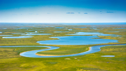Landscape of the arctic tundra in summer. Rivers, lakes, northern vegetation. View from above. The...