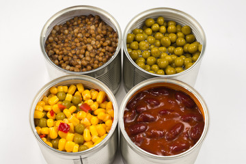 Canned food on white background. Green pea, beans, corn, lentils.