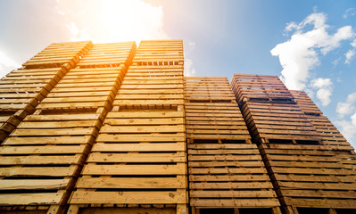 Wooden boxes stacked on each other. Outdoors. Blue sky background