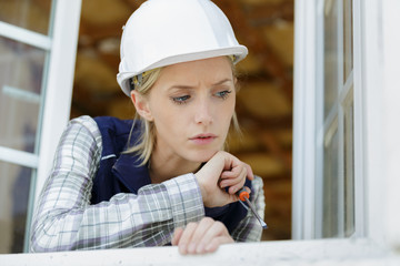 engineer builder woman in uniform looking out window