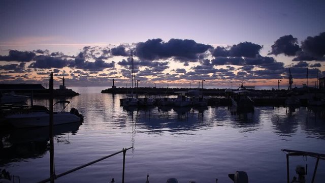 Cala Bona Marina at the start of a vibrant and golden sunrise.