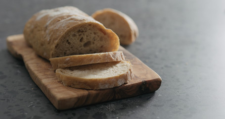 ciabatta bread on olive board