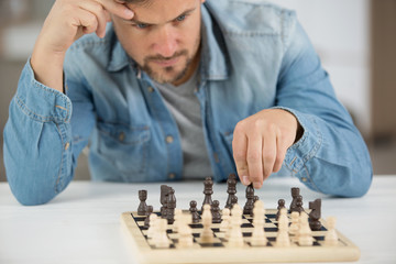 man playing chess at home