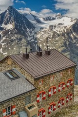 view of Breslauer Hütte, mountain chalet in the Austrian Alps, mountain lodge on the background of alpine peaks, base for climbing Wildspitze