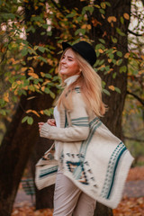 Autumn girl portraits. The model spins in