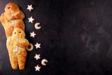 stutenkerl or weckmann. baked traditional german pastery on rustic background
