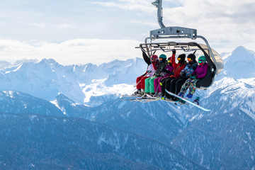 People on a ski funicular in the mountains.