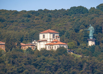 Fototapeta premium A famous panoramic point of Lake Maggiore with the statue of St Carlo Borromeo affectionately called San Carlone, Big Charlie