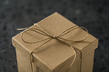 Closeup of tied twine bow on brown paper box