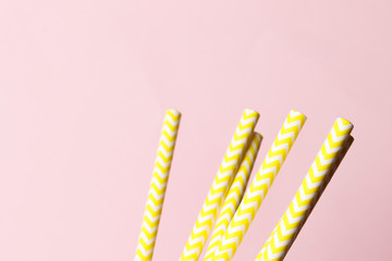 A lot of yellow paper straws on a background. Top view. Place for text. Party concept.