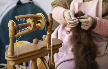 Spinning with a wooden spinning wheel