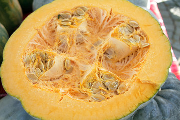 Half pumpkin with seeds. Pumpkin background texture . Squash pattern.