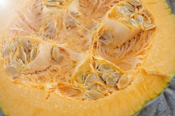 Half pumpkin with seeds. Pumpkin background texture . Squash pattern.