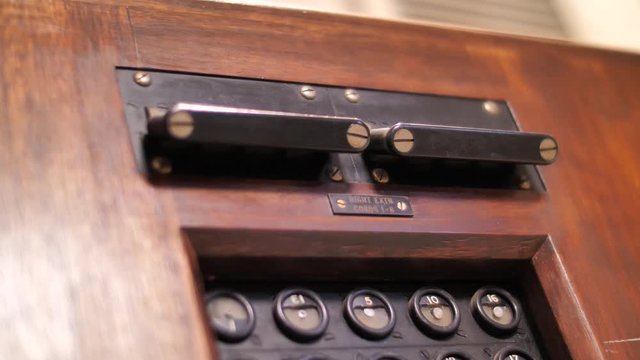 Close up on hand commuting switch of vintage telephone exchange 