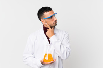 Young man over isolated white background with a scientific test tube