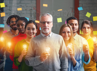 Teamwork and brainstorming concept with businessmen that share an idea with a lamp. Concept of...