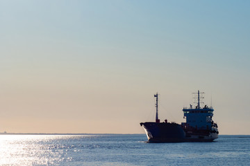 Fototapeta premium Seascape. Ship at dawn. The ship sails on a calm sea. Navigation. Ship with repair equipment on Board. Fleet. Service in the Navy.